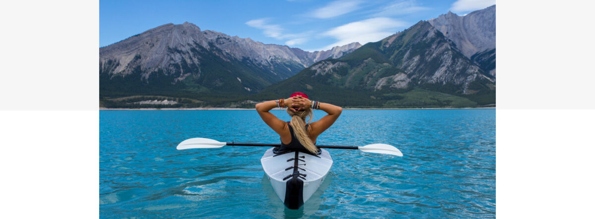 Canoeist with mountains in the background. Photo: Kalen Emsley from Unsplash.